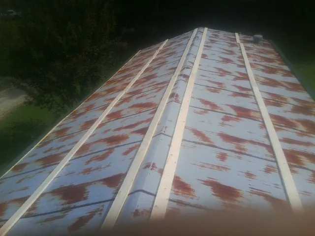 Rusted metal roof panels with new wood purlins before replacement — Storm Damage Roof Repair in Chunchula by Roofing Brothers